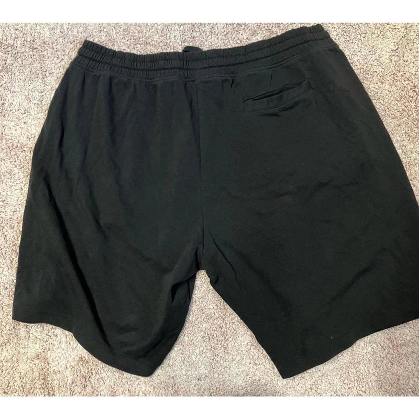 Black men’s casual shorts with drawstring elastic waistband and pockets.